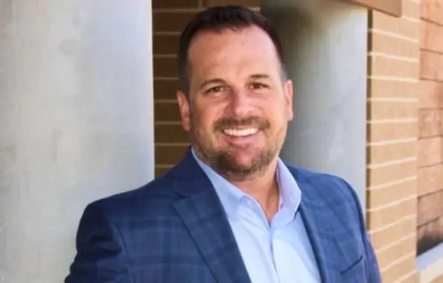 Dr. Adam Preece, dentist at McKinney dental practice, smiling in professional portrait.