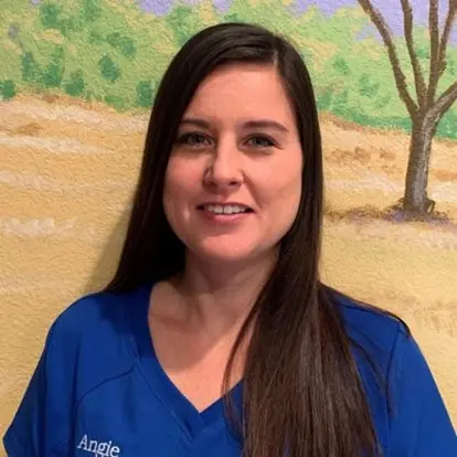 Angie, office manager at dental practice in McKinney, Texas, smiling for team photo.