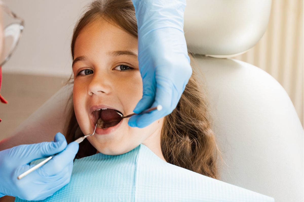 Pediatric dentist providing gentle dental care for a child in McKinney TX